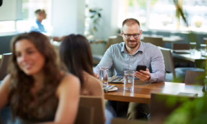 Man looking at his phone in a restaurant.
