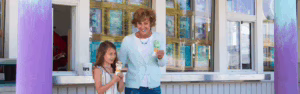 Grandmother and granddaughter eating ice cream.