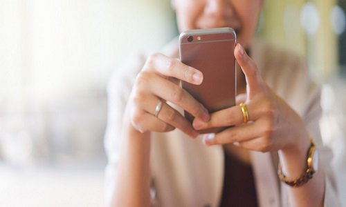 close up young woman looking at smartphone for video online chat with friends or surf the internet or playing mobile application in relax time, millennial technology lifestyle concept