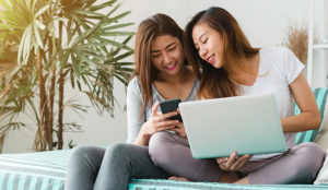 Two Girls on Devices | Independent Banking Services
