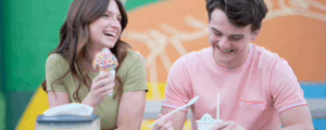 Two kids eating ice cream for Skip A Pay program in July Newsletter.