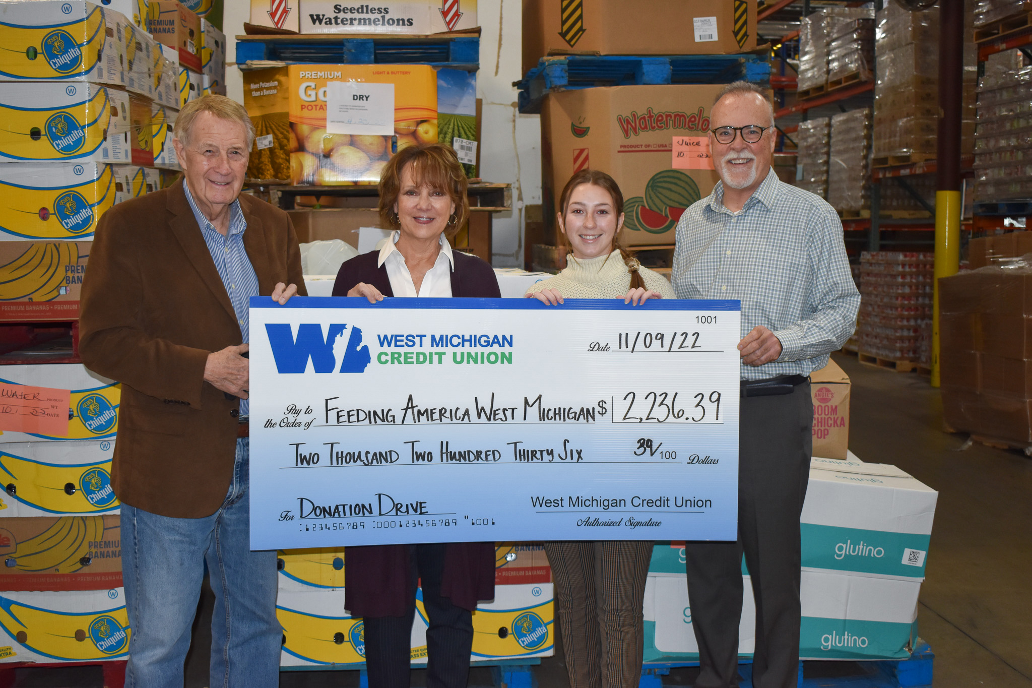West Michigan Credit Union team members presenting check to Feeding America West Michigan.