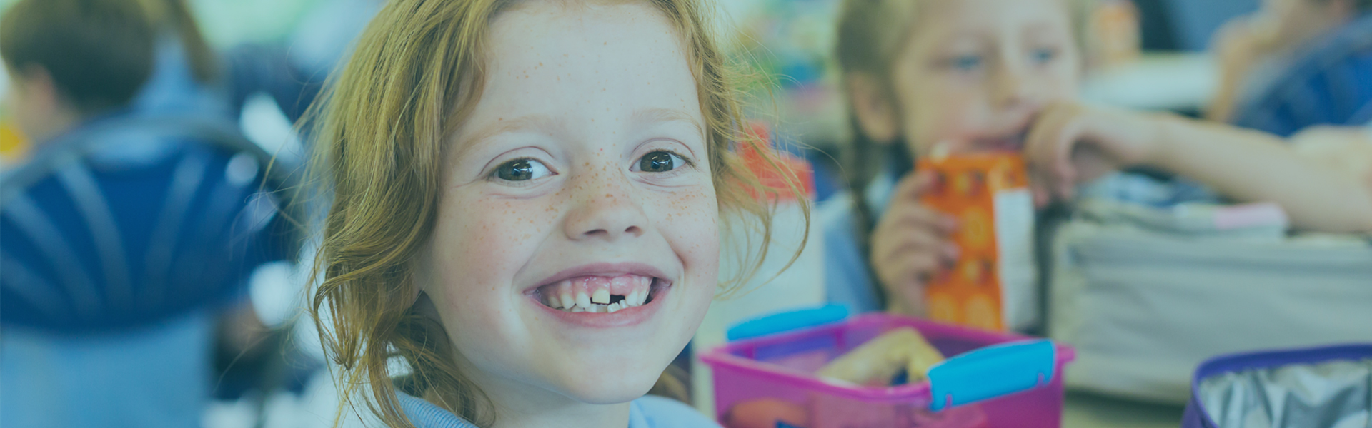 Youth Savings | Child smiling at camera missing teeth